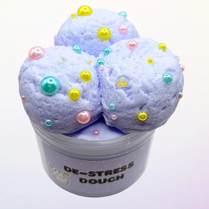 De-Stress Dough jar topped with three lavender scoops and pastel pearls