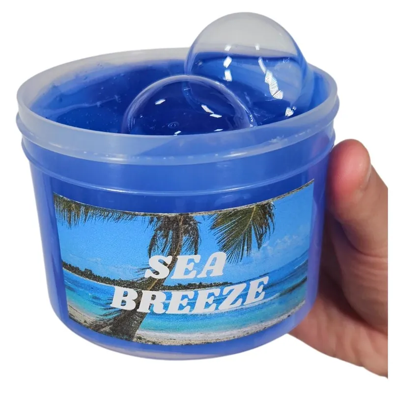 Sea Breeze jar of deep blue clear slime held in a hand